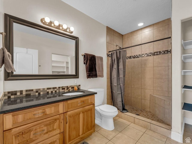 8503 S Spiral Jetty Cir W Unit 2083, West Jordan, UT 84081 - bathroom with vanity, tiled shower, a textured ceiling, and tile patterned floors
