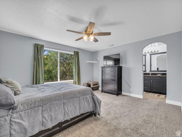 8503 S Spiral Jetty Cir W Unit 2083, West Jordan, UT 84081 - bedroom featuring light carpet, arched walkways, ensuite bath, and ceiling fan