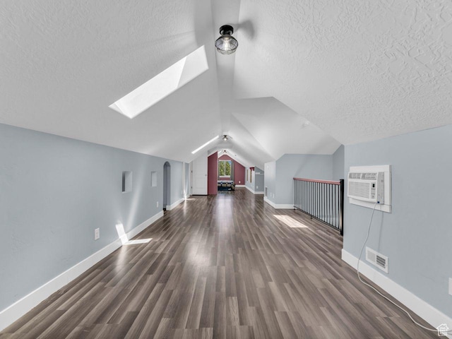8503 S Spiral Jetty Cir W Unit 2083, West Jordan, UT 84081 - additional living space featuring a wall mounted AC, a skylight, a textured ceiling, wood finished floors, and vaulted ceiling