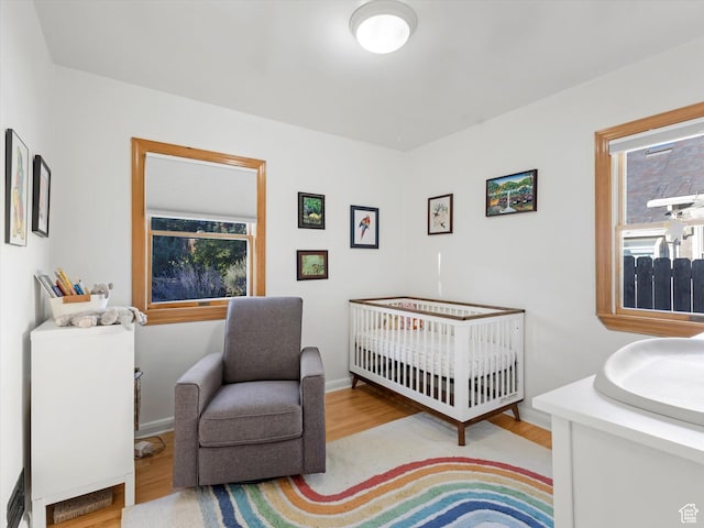 467 E 7th Ave N, Salt Lake City, UT 84103 - bedroom featuring wood finished floors and a nursery area