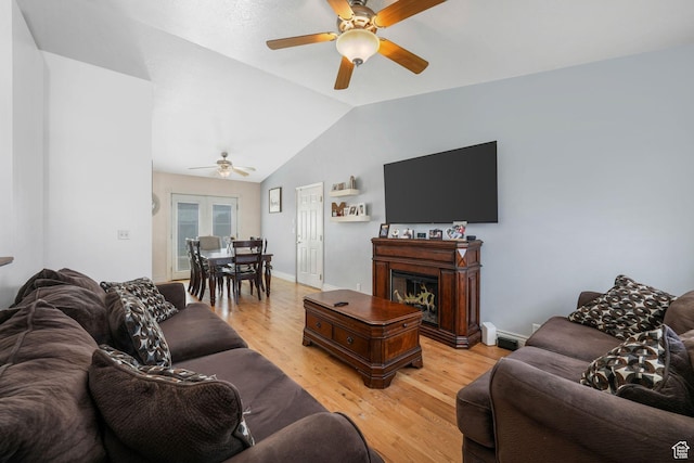 3142 S Sugar Bowl Ln, West Valley City, UT 84128 - living area featuring a ceiling fan, light wood-style floors, vaulted ceiling, and a glass covered fireplace