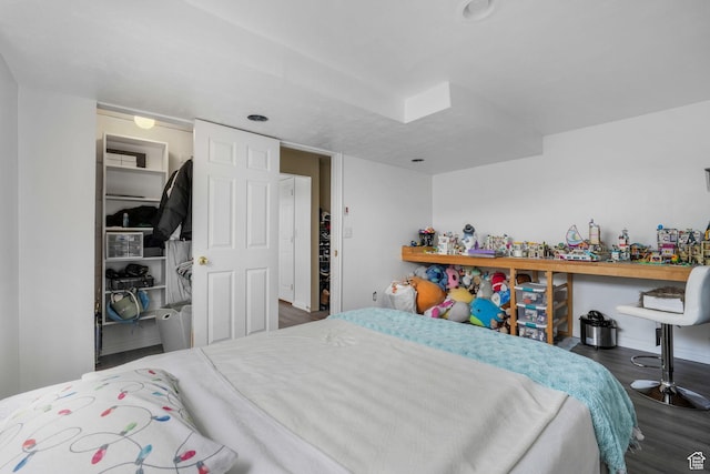 3142 S Sugar Bowl Ln, West Valley City, UT 84128 - bedroom with wood finished floors and a walk in closet