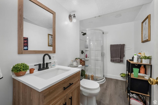 3142 S Sugar Bowl Ln, West Valley City, UT 84128 - full bathroom with vanity, a stall shower, wood finished floors, and a textured ceiling