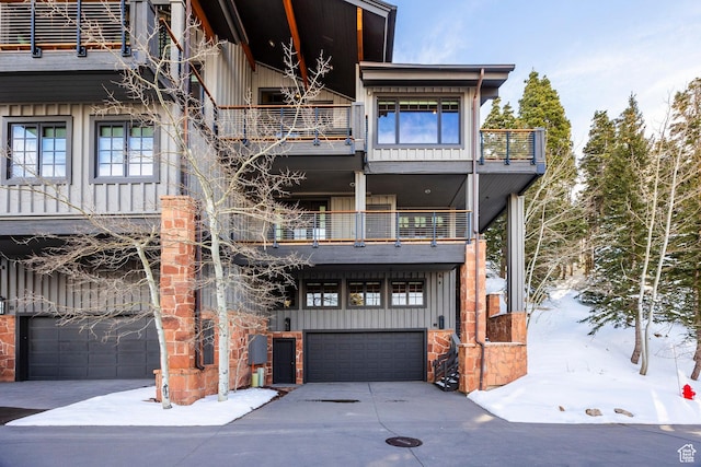 8200 Royal St Unit 43, Park City, UT 84060 - view of front of home with a balcony, board and batten siding, an attached garage, and concrete driveway