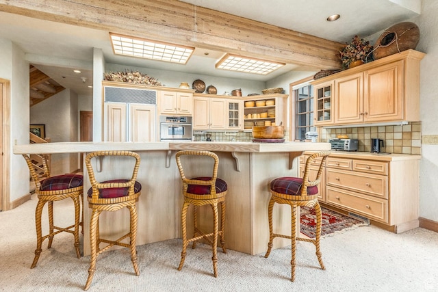 8200 Royal St Unit 43, Park City, UT 84060 - kitchen featuring oven, paneled built in refrigerator, a breakfast bar area, light brown cabinets, and light colored carpet
