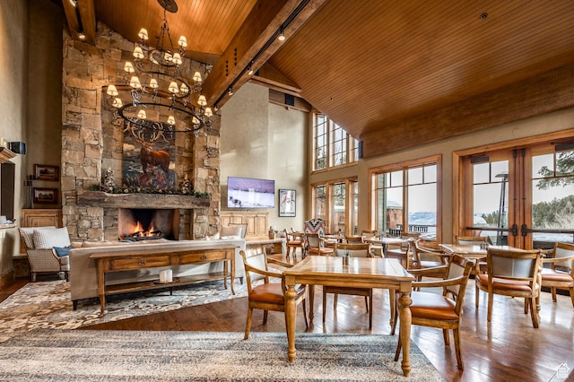 8200 Royal St Unit 43, Park City, UT 84060 - dining room with a wooden ceiling with exposed beams, high vaulted ceiling, wood-type flooring, a chandelier, and a stone fireplace