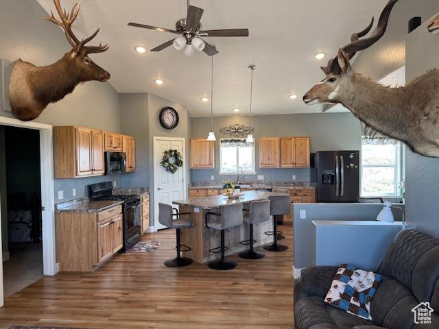 4058 E 5000 S, Vernal, UT 84078 - kitchen featuring black appliances, open floor plan, a breakfast bar area, ceiling fan, and recessed lighting