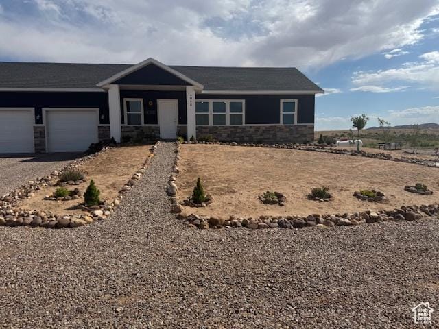 4058 E 5000 S, Vernal, UT 84078 - ranch-style house with an attached garage, stone siding, and driveway