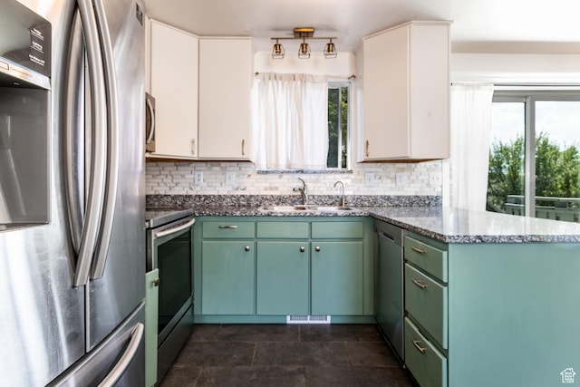 4287 W Stratus S, Kearns, UT 84118 - kitchen with appliances with stainless steel finishes, decorative backsplash, white cabinets, and a peninsula