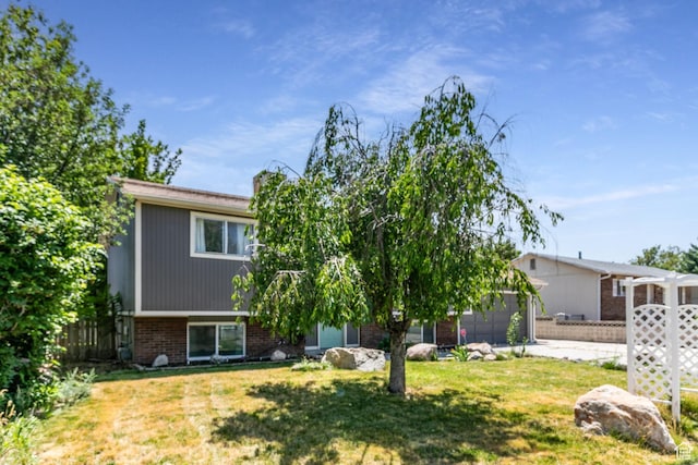 4287 W Stratus S, Kearns, UT 84118 - view of front of house featuring brick siding, an attached garage, and driveway
