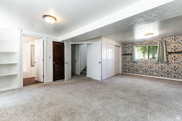 4287 W Stratus S, Kearns, UT 84118 - unfurnished bedroom with carpet, two closets, and wallpapered walls