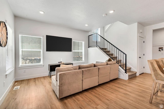 1162 N 550 W Unit 110, Tooele, UT 84074 - living room with light wood finished floors, stairs, healthy amount of natural light, and recessed lighting