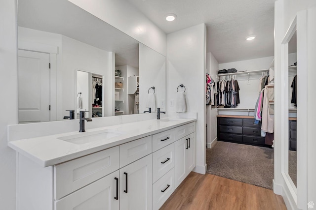 1162 N 550 W Unit 110, Tooele, UT 84074 - full bath featuring double vanity, a spacious closet, wood finished floors, and recessed lighting