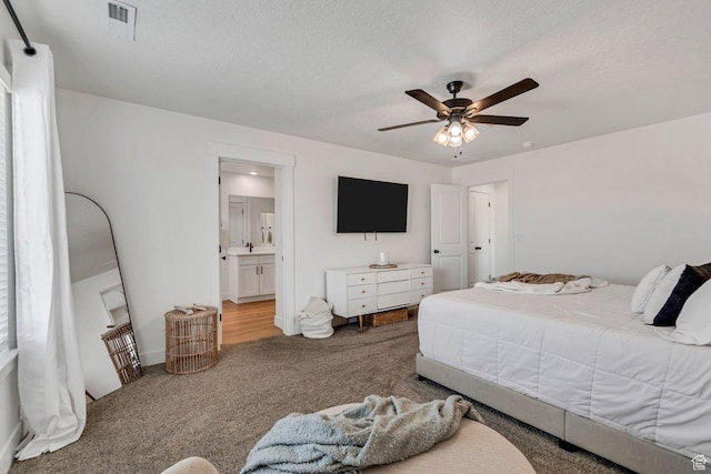 1162 N 550 W Unit 110, Tooele, UT 84074 - carpeted bedroom with connected bathroom, ceiling fan, and a textured ceiling