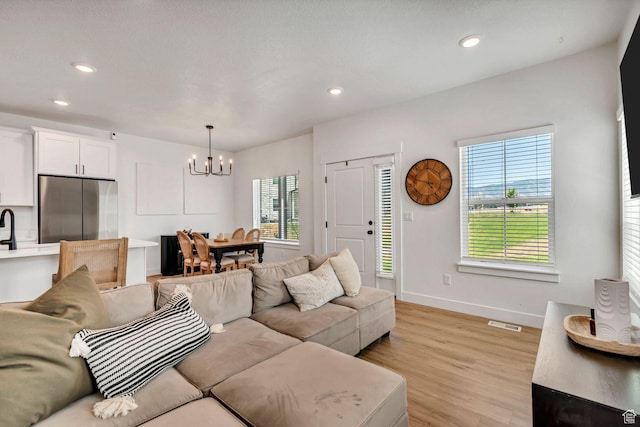 1162 N 550 W Unit 110, Tooele, UT 84074 - living area with a chandelier, light wood finished floors, and recessed lighting
