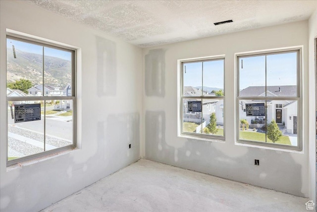 592 W Kennard Ln Unit 212, Farmington, UT 84025 - empty room featuring concrete floors and a textured ceiling