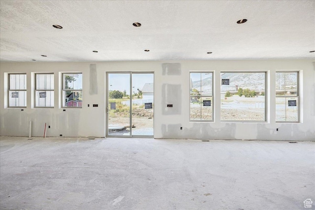 592 W Kennard Ln Unit 212, Farmington, UT 84025 - unfurnished living room featuring plenty of natural light, recessed lighting, and a textured ceiling