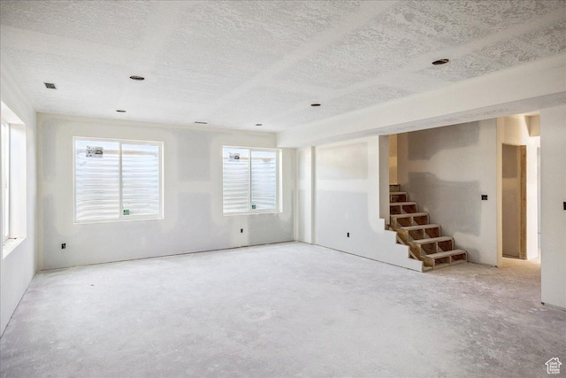 592 W Kennard Ln Unit 212, Farmington, UT 84025 - empty room with stairs, unfinished concrete floors, and a textured ceiling