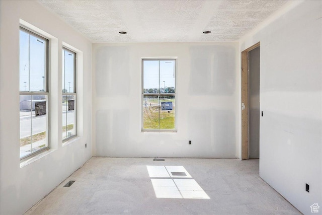 592 W Kennard Ln Unit 212, Farmington, UT 84025 - empty room with plenty of natural light and a textured ceiling