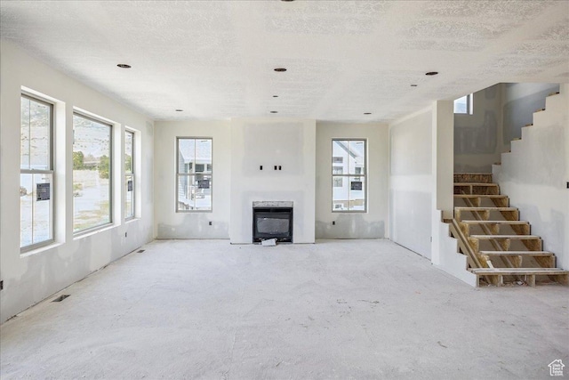 592 W Kennard Ln Unit 212, Farmington, UT 84025 - unfurnished living room featuring a fireplace and stairs