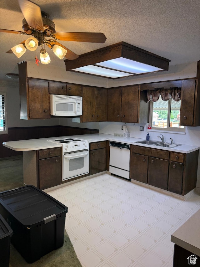 5166 S 2150 W, Roy, UT 84067 - kitchen featuring white appliances, a textured ceiling, dark brown cabinets, light floors, and light countertops