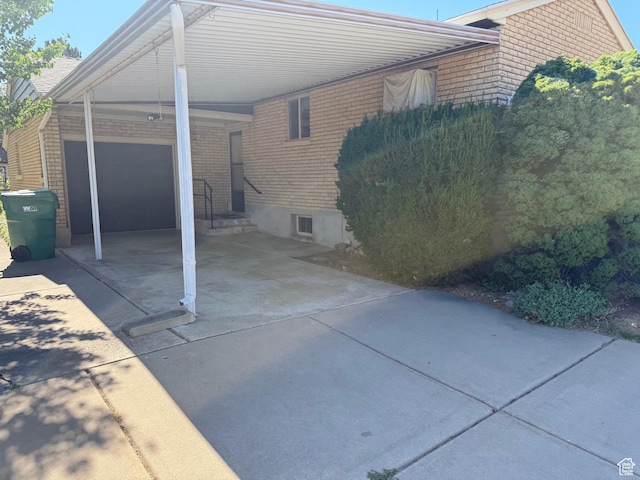 5166 S 2150 W, Roy, UT 84067 - view of side of property with driveway, an attached carport, and brick siding