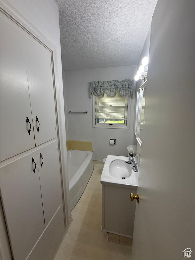 5166 S 2150 W, Roy, UT 84067 - bathroom featuring vanity, a textured ceiling, and a bath
