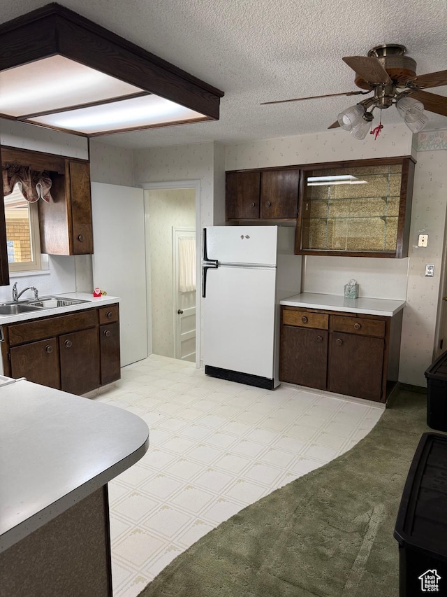 5166 S 2150 W, Roy, UT 84067 - kitchen featuring freestanding refrigerator, ceiling fan, light countertops, dark brown cabinets, and a textured ceiling