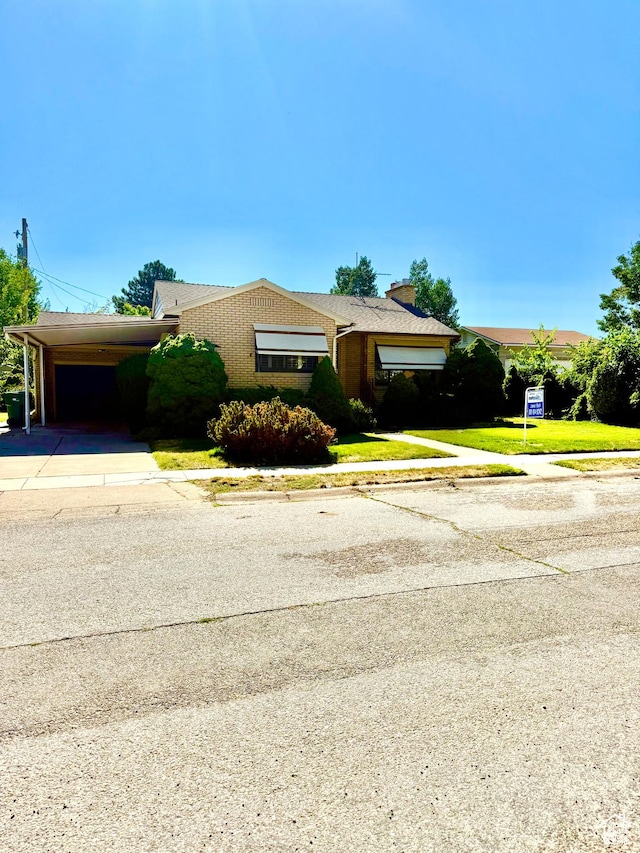 5166 S 2150 W, Roy, UT 84067 - ranch-style house featuring concrete driveway, a chimney, a front lawn, and an attached carport
