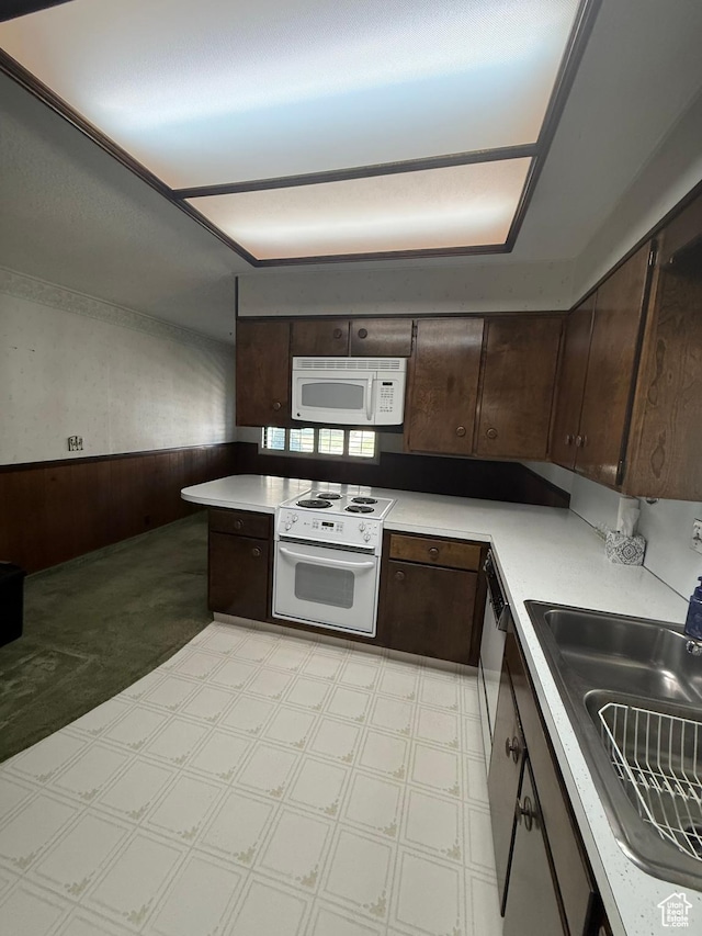 5166 S 2150 W, Roy, UT 84067 - kitchen featuring white appliances, dark brown cabinetry, wainscoting, light floors, and light countertops