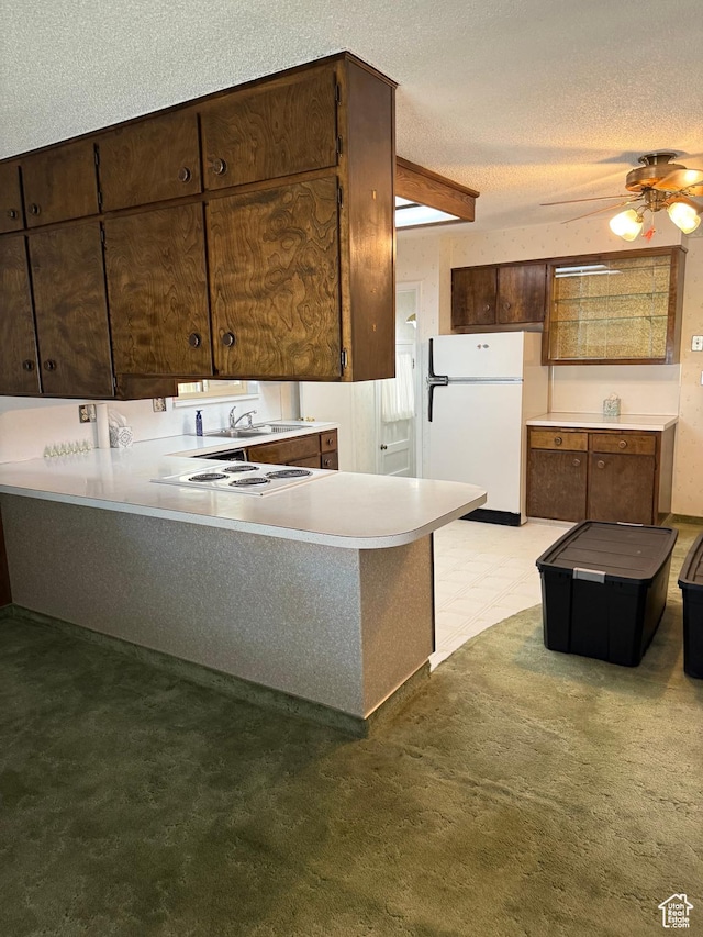 5166 S 2150 W, Roy, UT 84067 - kitchen featuring white appliances, a textured ceiling, a peninsula, ceiling fan, and light countertops