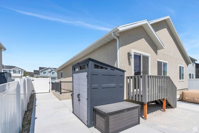 7194 N Clear Meadow Way, Eagle Mountain, UT 84005 - back of property with a shed, a fenced backyard, stucco siding, a residential view, and a patio