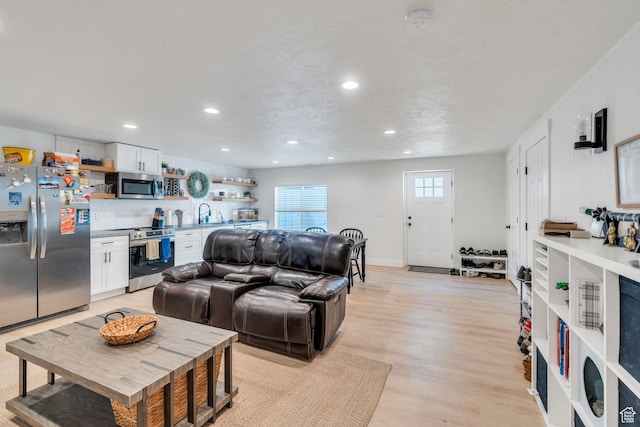 7194 N Clear Meadow Way, Eagle Mountain, UT 84005 - living room featuring recessed lighting and light wood-style flooring
