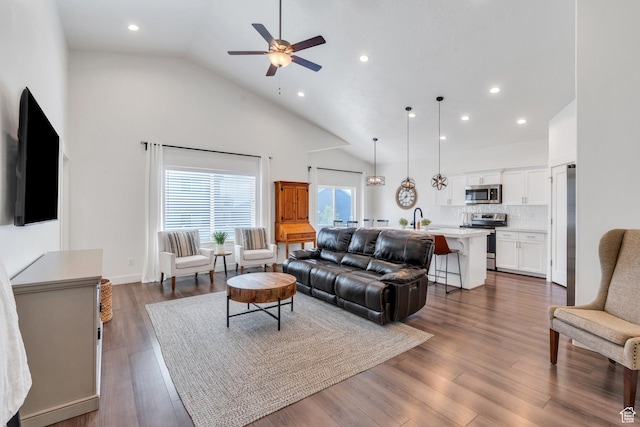 7194 N Clear Meadow Way, Eagle Mountain, UT 84005 - living area with high vaulted ceiling, a ceiling fan, recessed lighting, and dark wood-style flooring