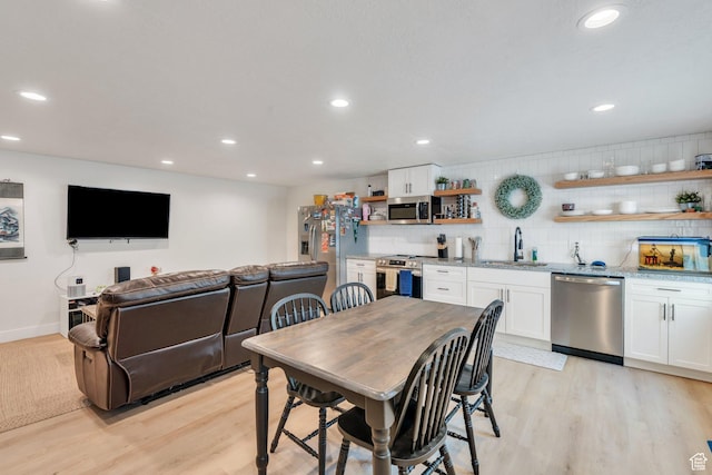 7194 N Clear Meadow Way, Eagle Mountain, UT 84005 - dining space with light wood-style floors, wet bar, and recessed lighting
