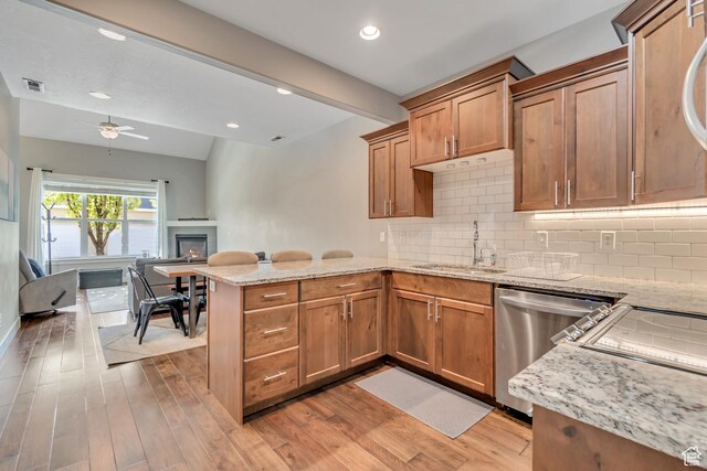 7162 S Beamon St W, West Jordan, UT 84084 - kitchen featuring stainless steel dishwasher, a peninsula, open floor plan, a ceiling fan, and light stone countertops