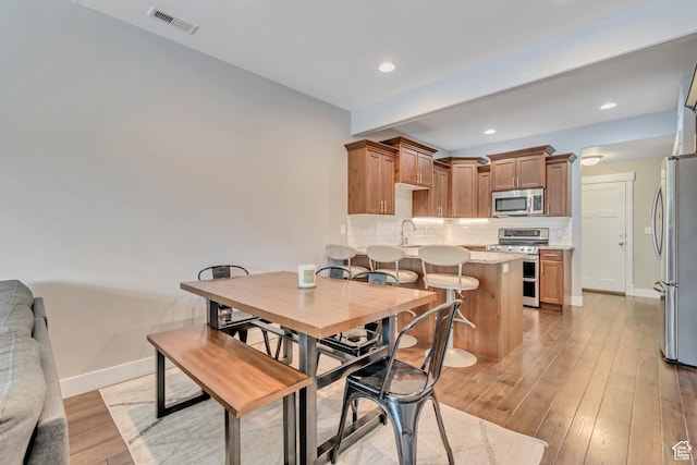 7162 S Beamon St W, West Jordan, UT 84084 - dining area featuring light wood-style floors, beam ceiling, and recessed lighting