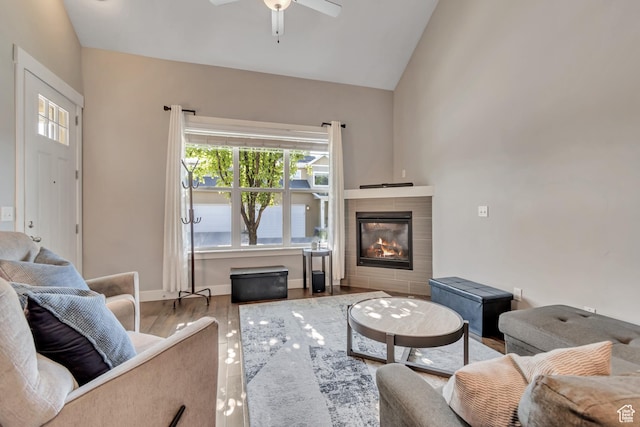 7162 S Beamon St W, West Jordan, UT 84084 - living area featuring a fireplace, a ceiling fan, wood finished floors, and lofted ceiling