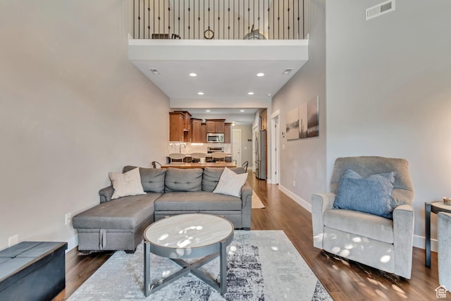 7162 S Beamon St W, West Jordan, UT 84084 - living area with dark wood-style floors, a high ceiling, and recessed lighting