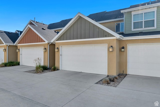 7162 S Beamon St W, West Jordan, UT 84084 - view of front facade with board and batten siding, roof with shingles, a garage, concrete driveway, and stucco siding