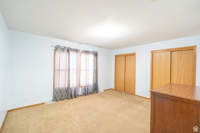 975 S 400 E, Moab, UT 84532 - unfurnished bedroom featuring light colored carpet and two closets