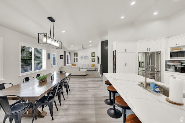 1569 Troon Cir, Syracuse, UT 84075 - dining space featuring light wood-style floors, recessed lighting, ceiling fan, and vaulted ceiling