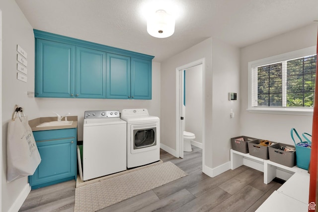 1569 Troon Cir, Syracuse, UT 84075 - laundry room with cabinet space, washing machine and dryer, and light wood-type flooring