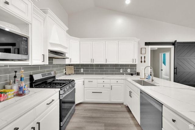 1569 Troon Cir, Syracuse, UT 84075 - kitchen featuring stainless steel appliances, lofted ceiling, tasteful backsplash, white cabinetry, and light wood-style flooring