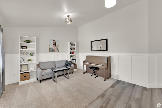 1569 Troon Cir, Syracuse, UT 84075 - sitting room with vaulted ceiling, a wainscoted wall, wood finished floors, and a decorative wall