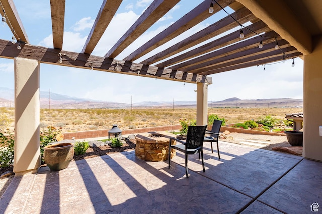 4352 W 2440 S, Hurricane, UT 84737 - view of patio featuring a mountain view, a pergola, a view of rural / pastoral area, and a fire pit