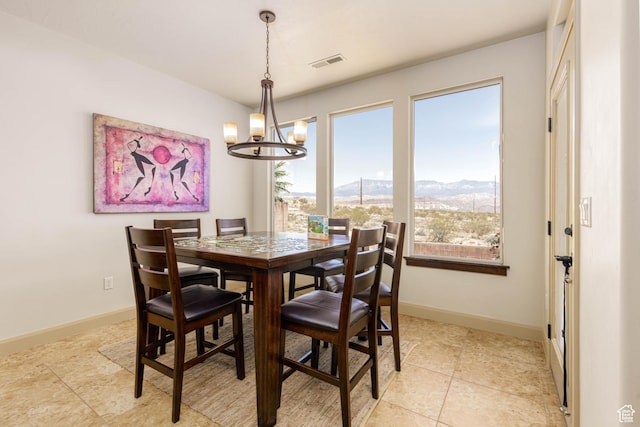 4352 W 2440 S, Hurricane, UT 84737 - dining area with a chandelier, plenty of natural light, a mountain view, and light tile patterned flooring