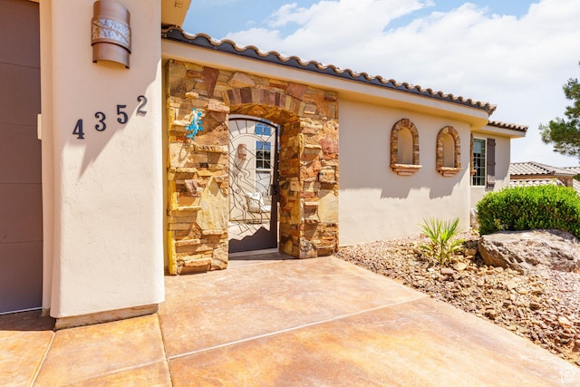 4352 W 2440 S, Hurricane, UT 84737 - entrance to property featuring stone siding, stucco siding, and a tiled roof