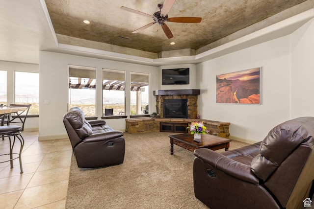 4352 W 2440 S, Hurricane, UT 84737 - living area featuring a raised ceiling, a ceiling fan, a fireplace, and light tile patterned floors