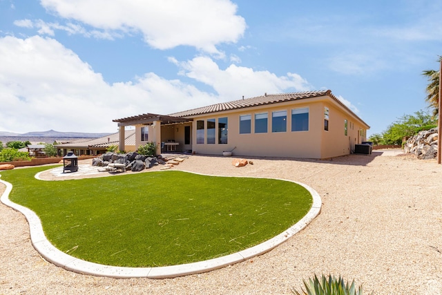4352 W 2440 S, Hurricane, UT 84737 - back of house featuring a pergola, a patio, a tile roof, stucco siding, and a lawn